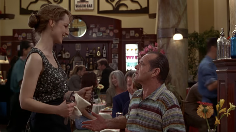 Jack Nicholson's Melvin Udall looks up at Helen Hunt's Carol Connelly as he sits in a restaurant in As Good As it Gets
