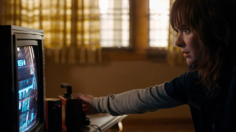 Joyce looking at a TV set in Stranger things