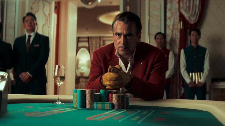 Colin Farrell as Lord Doyle sitting at a craps table in Ballad of a Small Player
