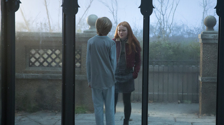 Max Martini as Eli talking with Sadie Sink as Haley through glass in Eli