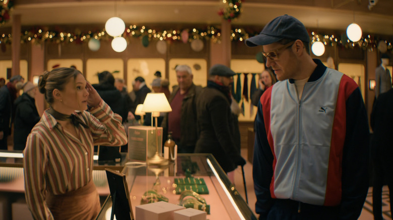 Olivia Holt's Sophie Arbus stands oppositer Connor Swindell's Nick O'Connor in a department store in Jingle Bell Heist