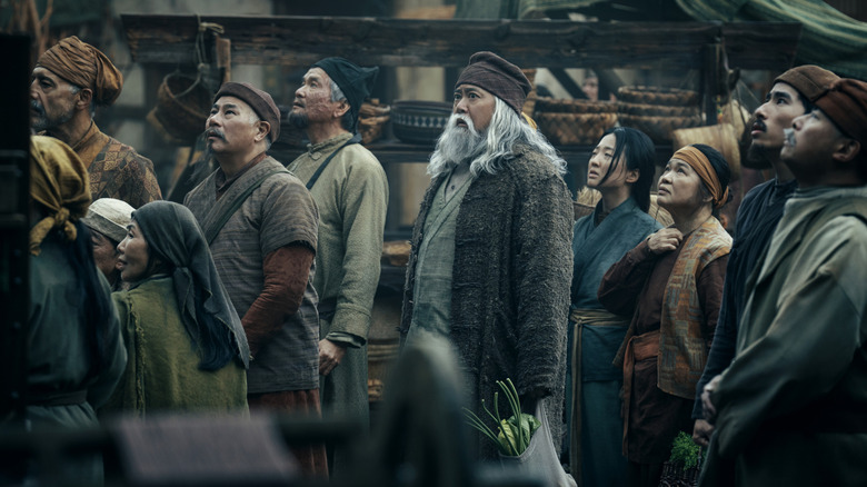Uncle Iroh standing with a crowd in Avatar: The Last Airbender