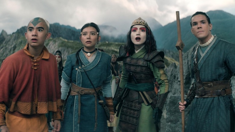 Aang, Katara, Suki, and Sokka looking up in alarm in Avatar: The Last Airbender