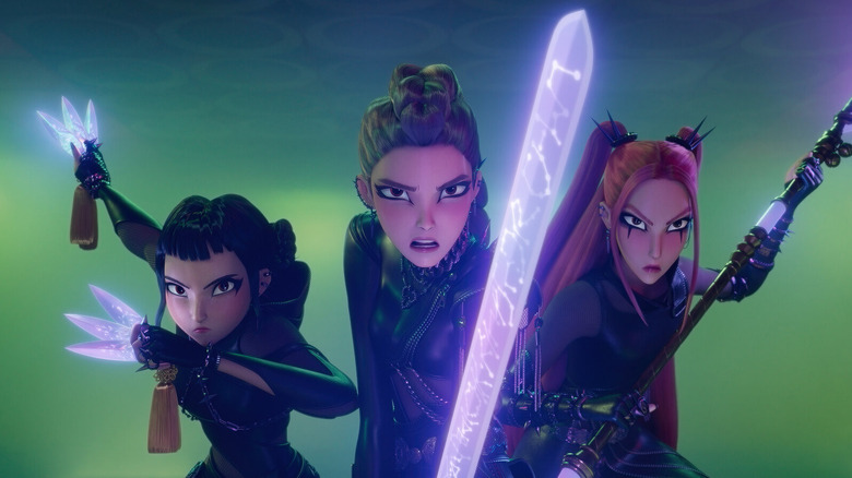 HUNTR/X stars Rumi, Zoey and Mira, dressed in black leather demon hunting gear and armed with their glowing purple energy weapons, prepare to take down demons in "KPop Demon Hunters"