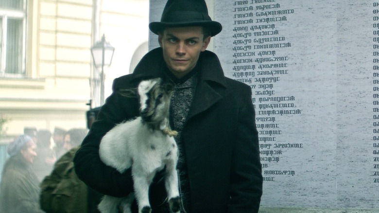 Kaz Brekker holding Milo the Goat in Season 1 of Shadow and Bone