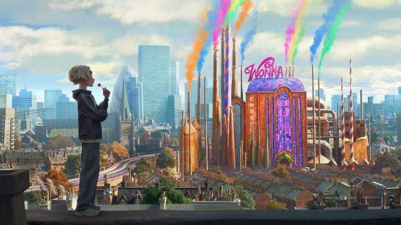 Kit Connor as the voice of Charlie Paley standing on a street overlooking the colorful Wonka factory in Charlie vs. the Charlie Factory
