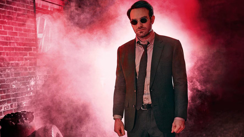 Daredevil still showing Matt Murdock wearing a suit in a foggy alley