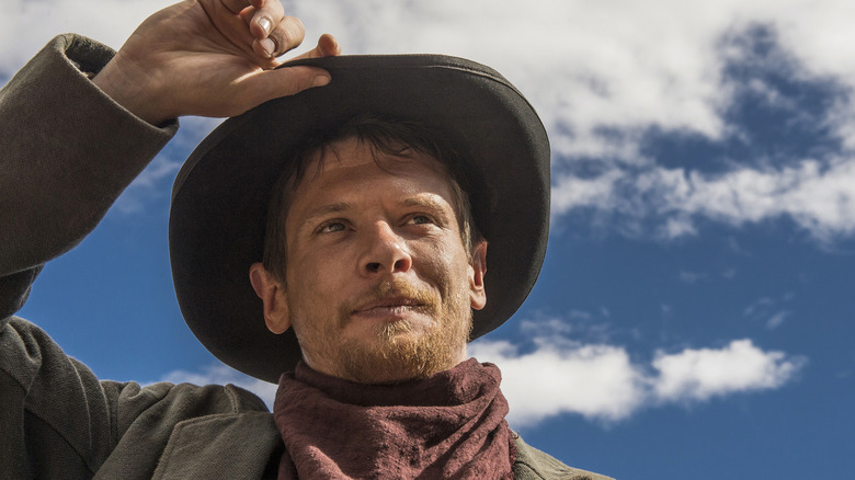Jack O'Connell tips his cowboy hat as Roy Goode in Godless
