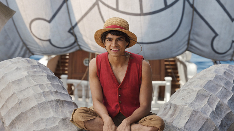 Luffy sitting on the bow of the Going Merry in One Piece