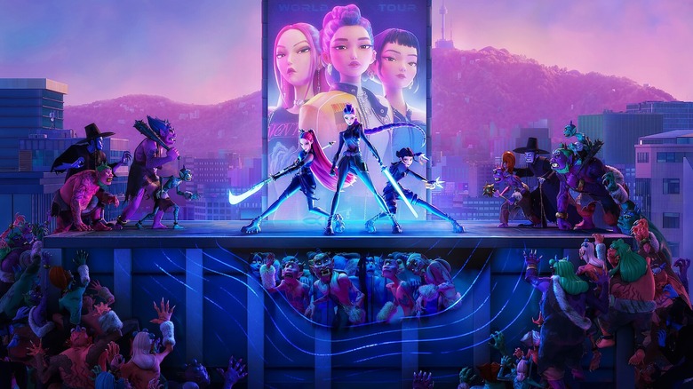 Huntrix on stage beiing flanked by demons in KPop Demon Hunters