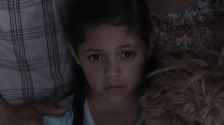 Annie holds her doll and looks concerned in Insidious: Chapter 2