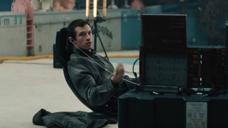 Callum Turner as Case plugged into his console in Neuromancer