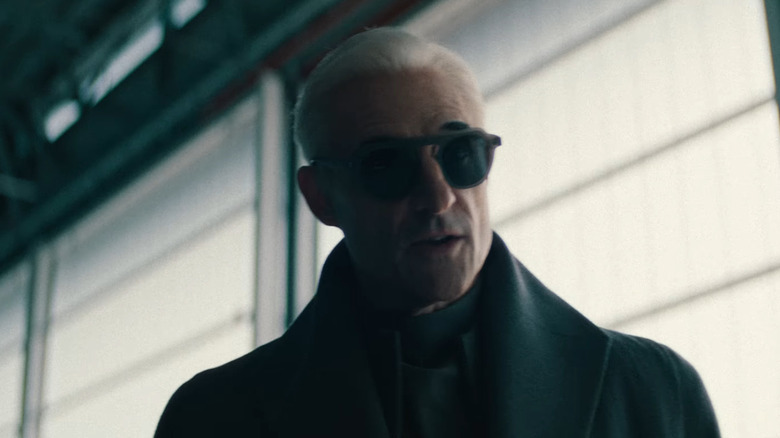 Mark Strong as Armitage with his glasses on in Neuromancer