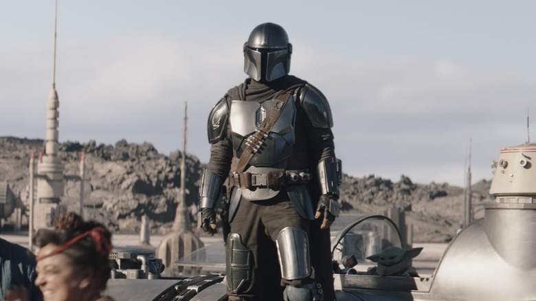 Din Djarin and Grogu standing together on a spaceship in The Mandalorian