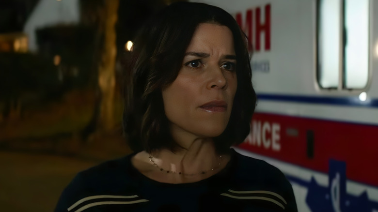 Sidney Prescott standing next to an ambulance in 