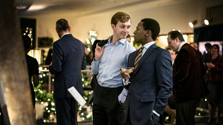 Robert and Gus talking to each other at a party on Industry