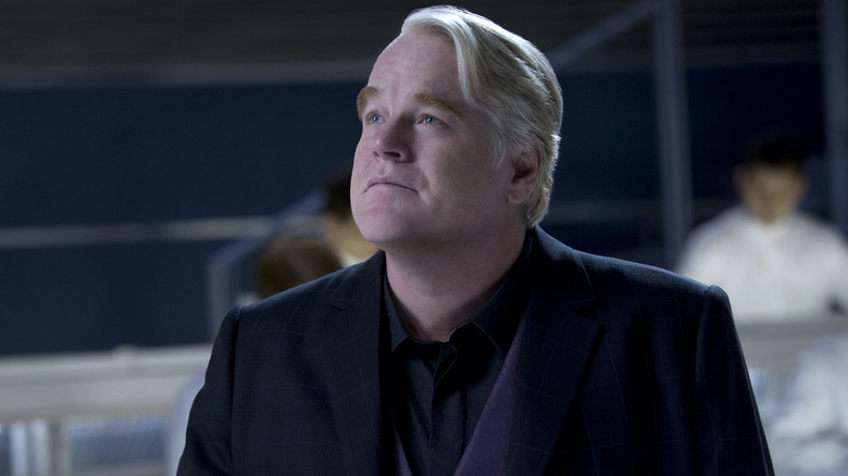 Philip Seymour Hoffman as Plutarch looking upwards in The Hunger Games: Catching Fire