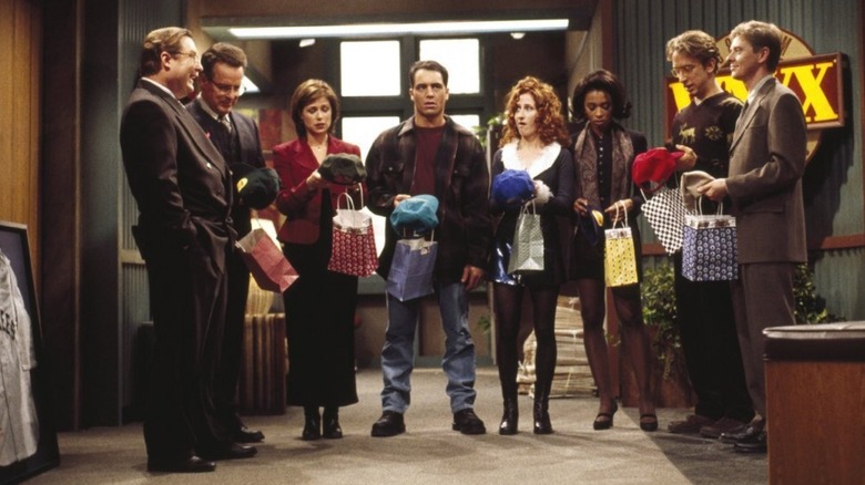 Staff of WNYX holding gift bags on NewsRadio