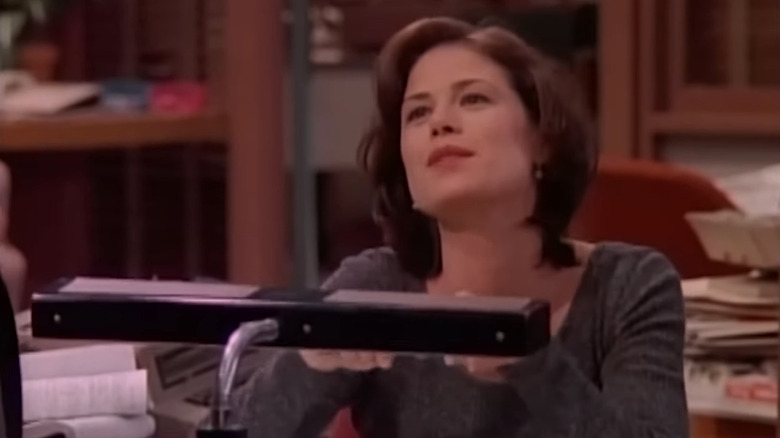 Lisa (Maura Tierney) looking smug