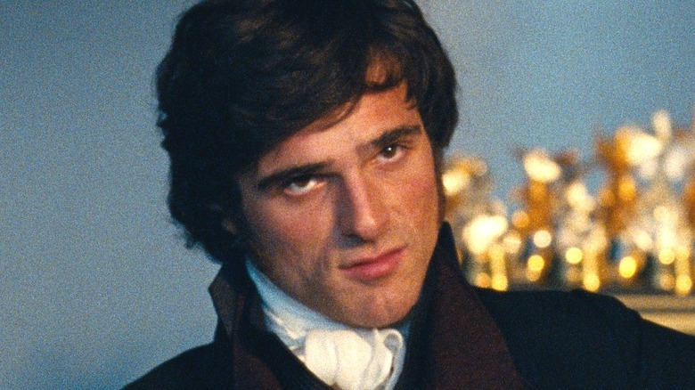 Jacob Elordi as Heathcliff sitting on the couch in Wuthering Heights (2026)