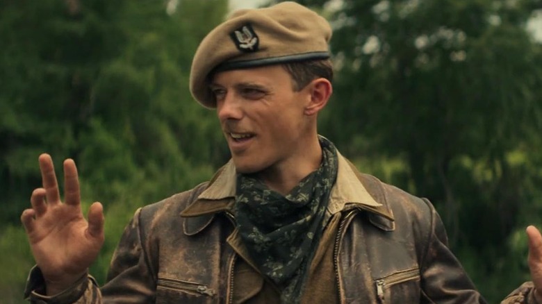 Jack Barton as John Tonkin with his hands up in Rogue Heroes