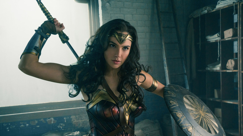 Gal Gadot as Wonder Woman taking out her sword in Wonder Woman