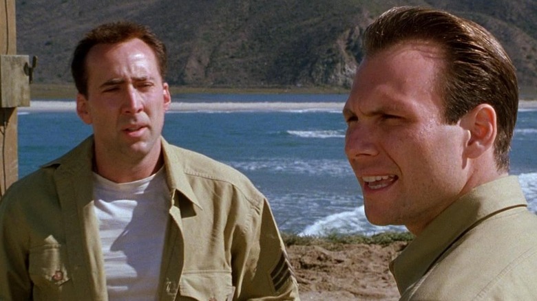 Nicolas Cage as Sergeant Joe Enders and Christian Slater as Sergeant Peter Henderson standing near an ocean in Windtalkers