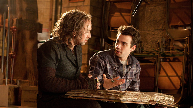 Nicolas Cage as Balthazar Blake sitting next to Jay Baruchel as Dave Stutler in The Sorcerer's Apprentice
