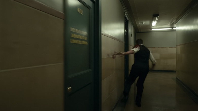 Bradley Cooper running through a hallway