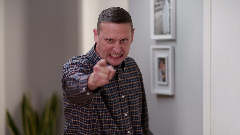 Tim Robinson pointing toward the camera with a wild look on his face