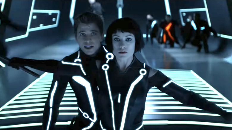 Quorra protects Sam in Tron: Legacy