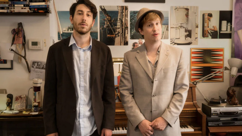 Matt Johnson and Jay McCaroll stand in front of their piano in Nirvanna the Band the Show
