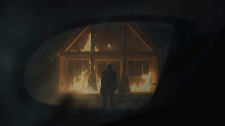 A burning house in a side mirror