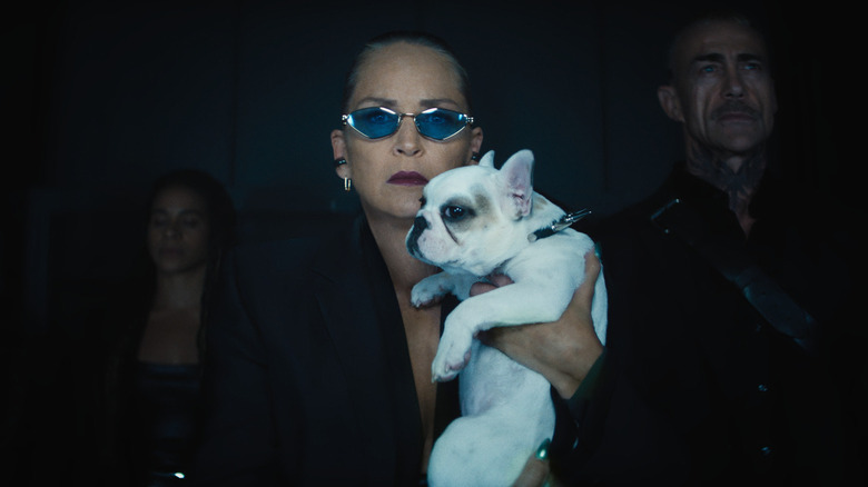 Lendina holding her pet dog in Nobody 2
