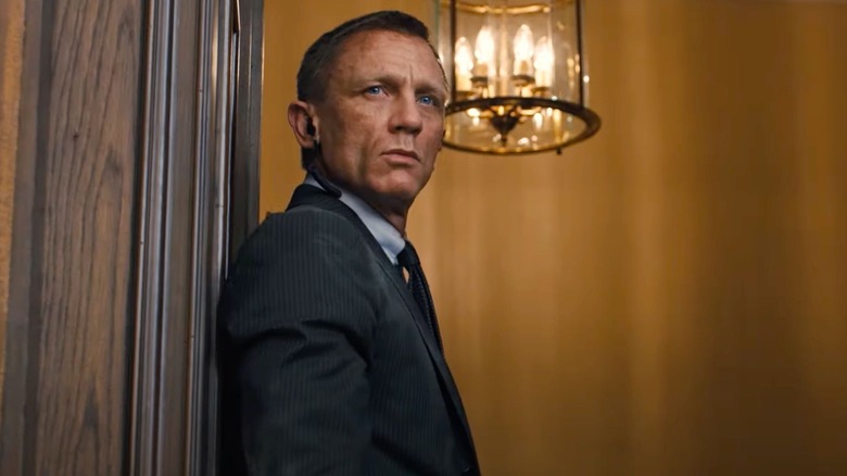 daniel craig as james bond standing in a doorway