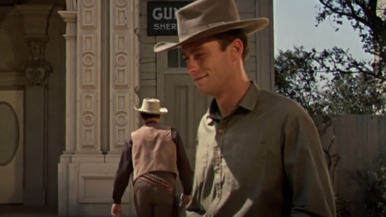 Clint Eastwood's Tom the ranch hand smiles as he walks away from John Agar's Sheriff Bill Jorden in Star in the Dust