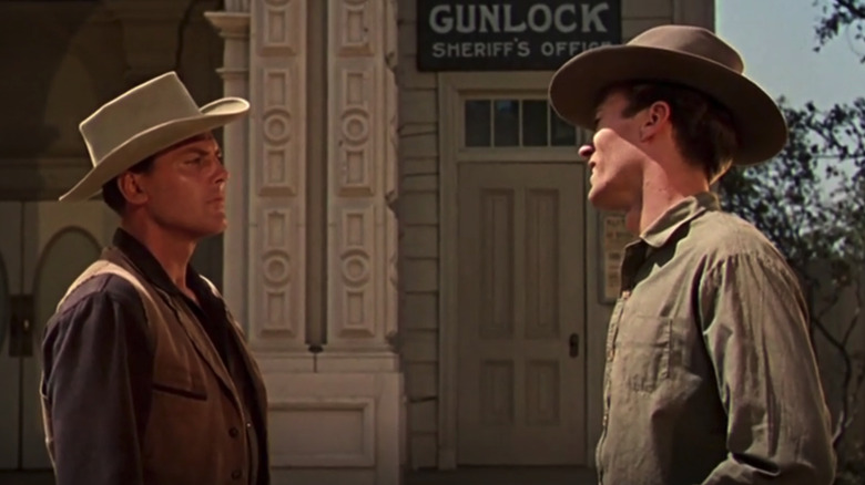 John Agar's Sheriff Bill Jorden stands opposite Clint Eastwood's Tom the ranch hand in a street in Star in the Dust