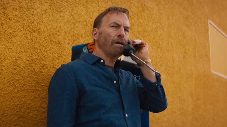 Bod Odenkirk as Hutch talking on the phone against a yellow wall in Nobody 2
