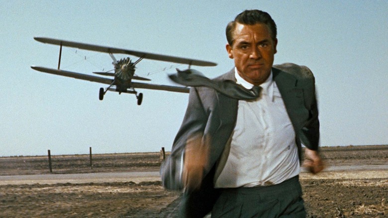 Cary Grant as Roger O. Thornhill flees a crop duster in North by Northwest