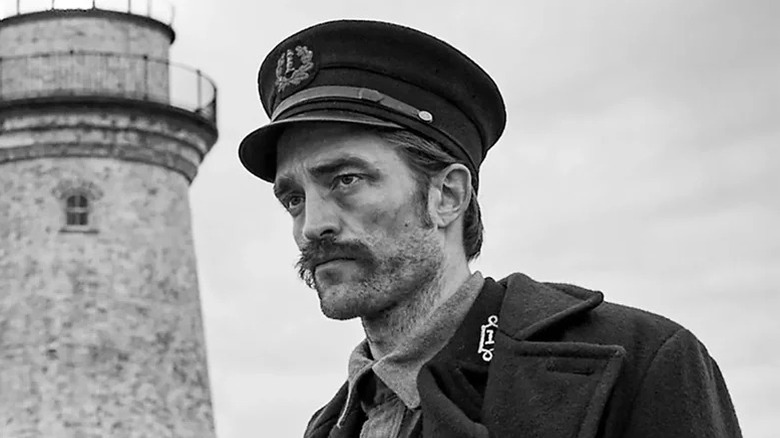Efrem Winslov/Thomas Hooda Robert Patinson stands near his lighthouse, looking away in the lighthouse
