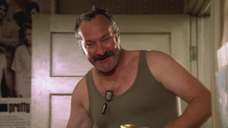 Randy Quaid as Mr. Briggs in Not Another Teen Movie, wearing a green tank top and dog tags