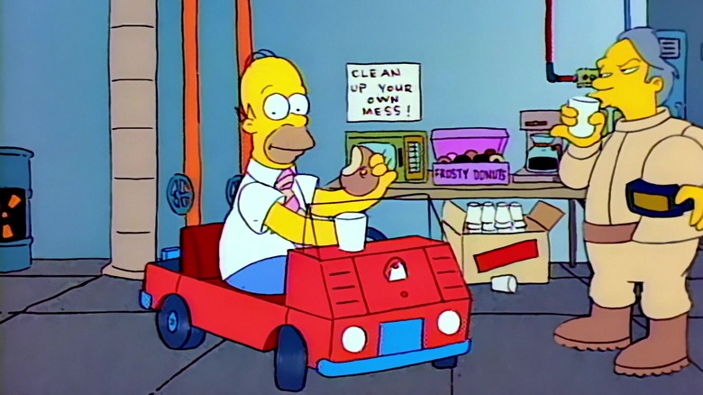 Homer eating a donut at work in The Simpsons