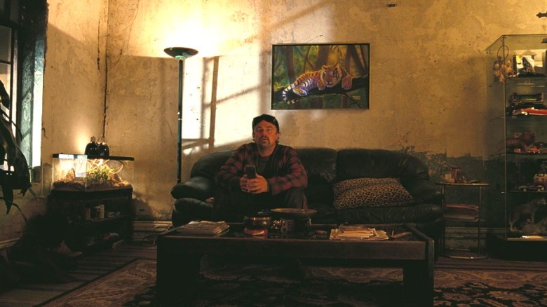 Bob sitting on Sensei's couch in One Battle After Another