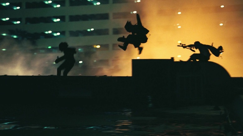 Skateboarders leaping across a rooftop in One Battle After Another