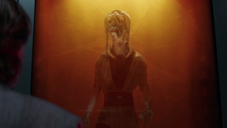 Obi-Wan stares aghast at the amber tomb of Master Tera Sinube