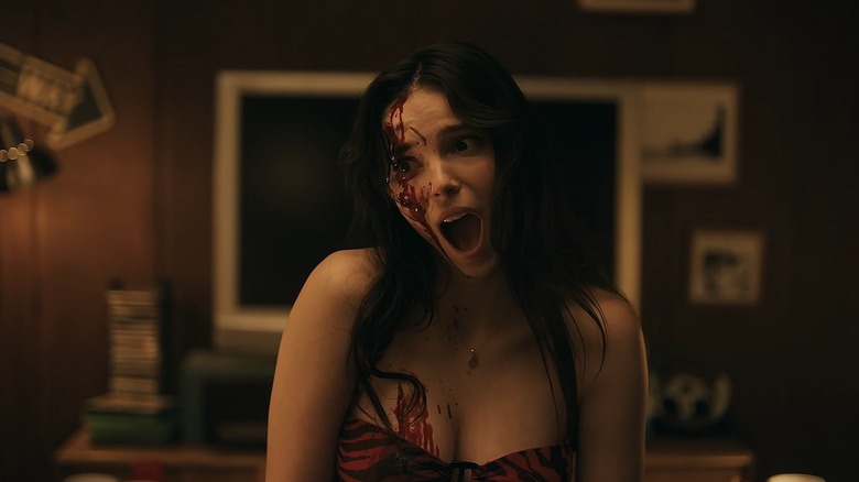 Inde Navarrette as Nikki with her mouth open covered in blood in Obsession