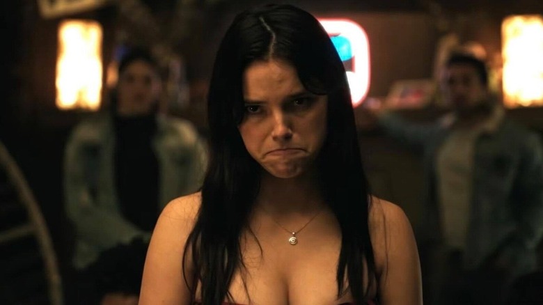 Inde Navarrette as Nikki frowning at a party in Obsession