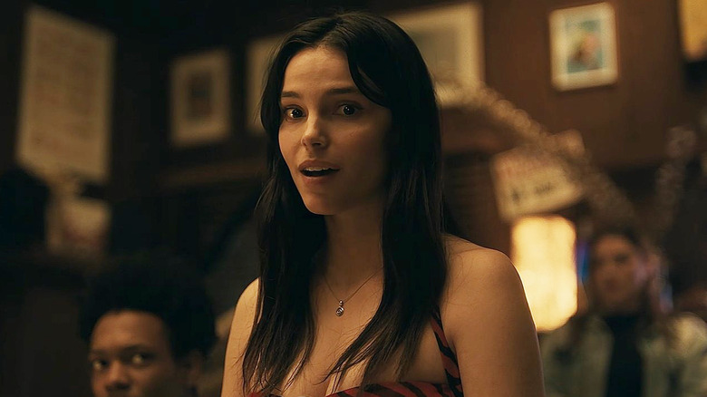 Inde Navarrette as Nikki speaking to Bear at a party in Obsession