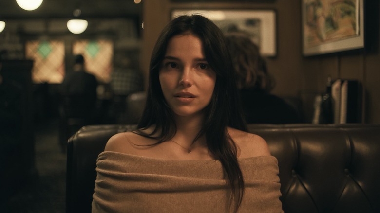 Inde Navarrette as Nikki sitting at a diner table in Obsession