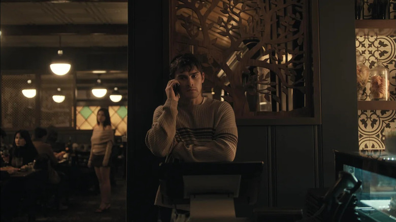 Michael Johnston as Bear on the phone with Inde Navarrette as Nikki lurking in the background in Obsession